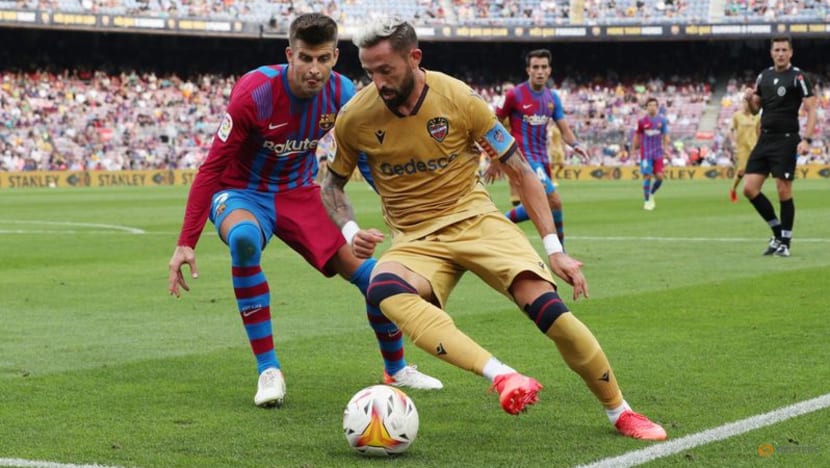 Levante's Jose Luis morles in action with FC Barcelona's Gerard pique