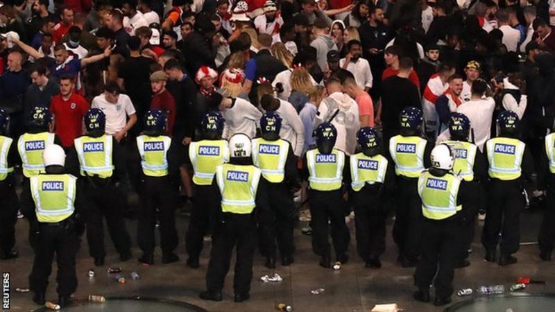 Police standing in front of England fans at Wembley during the Euro 2020 final
