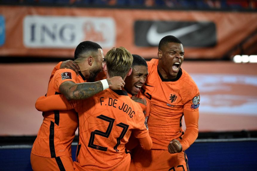 Netherlands' forward Steven Bergwijn (centre) celebrates with teammates after scoring his team's first goal.
